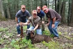 Group of hunters posing with Black Hawaiian Ram kill
