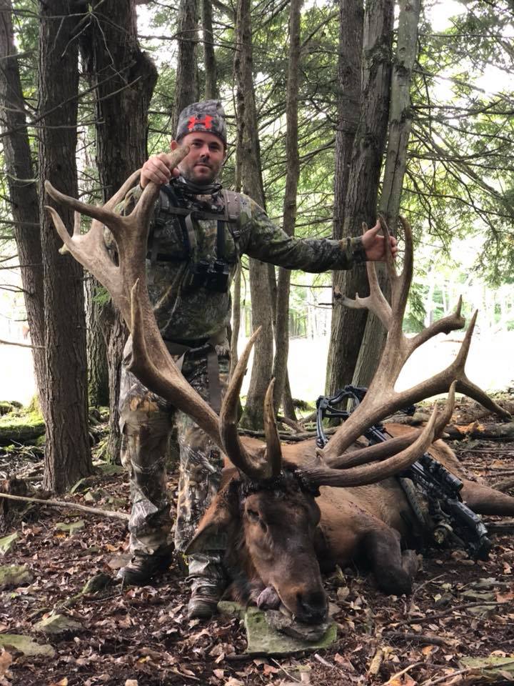 Hunter posing with elk kill