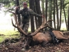 Hunter posing with elk kill and crossbow
