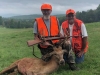 Couple of hunters posing with red stag kill