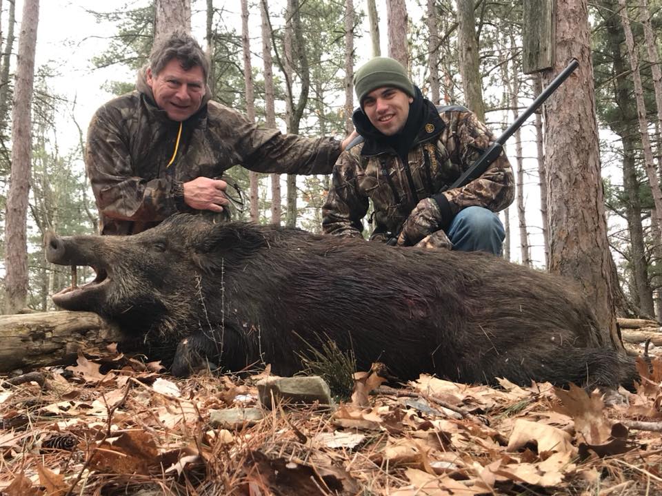 Boar Hunters posing with boar
