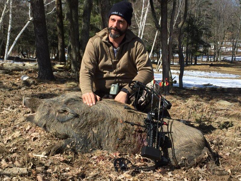 Hunter posing with wild boar he shot