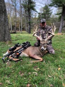 Hunter with whitetail deer kill