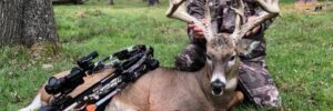 Hunter posing with whitetail deer he shot