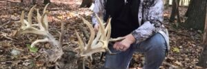Hunter next to whitetail deer