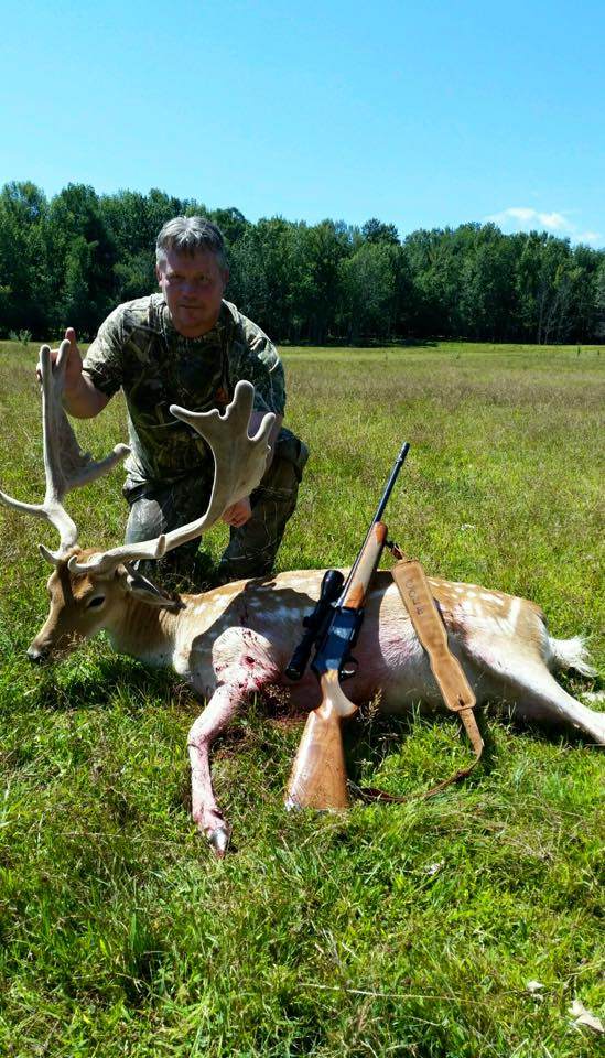Hunter with Fallow Deer