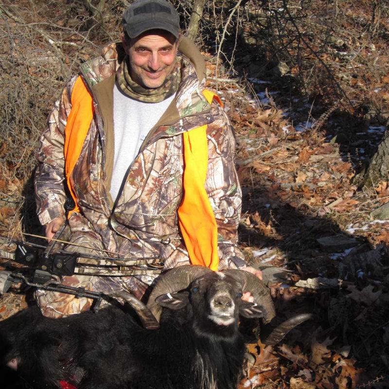 Hunter Posing With Black Hawaiian Ram Trophy