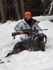 Group of hunters posing with Black Hawaiian Ram kill