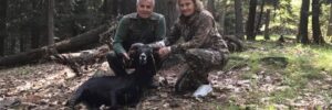 Hunting Couple Posing Next to Black Hawaiian Ram