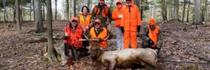 Group of Hunters around Trophy Elk