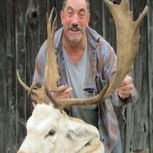 Man posing with hunted fallow deer