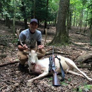 Man posing with hunted fallow deer