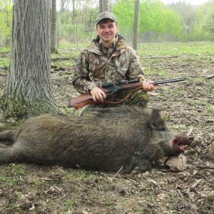 Boar Hunter posing with dead boar