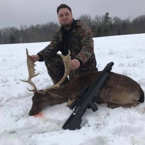 Man posing with hunted fallow deer