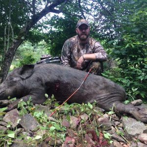 Hunter Posing With Boar
