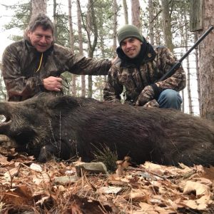 Boar Hunters posing with boar