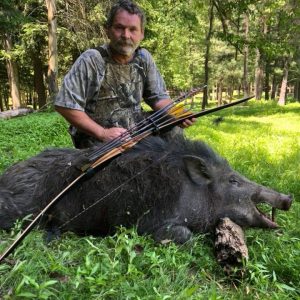 Hunter posing with a giant boar