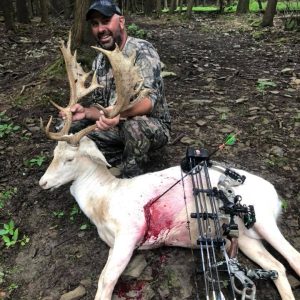 Man posing with hunted fallow deer