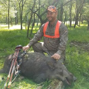 Hunter posing with wild boar