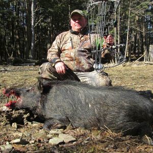 Hunter Posing Next to a Trophy Boar