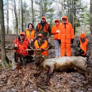 Group of Hunters around Trophy Elk