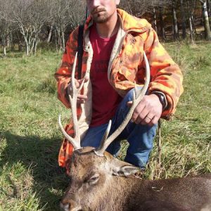 Hunter posing with a sika deer