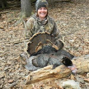 Woman posing with hunted turkey