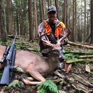 Hunter with Whitetail Deer
