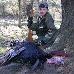 Teen posing with hunted turkey
