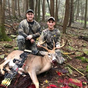 Two Hunters with Whitetail Deer