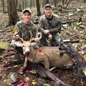 Two Hunters with Whitetail Deer