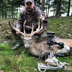 Hunter posing with whitetail deer