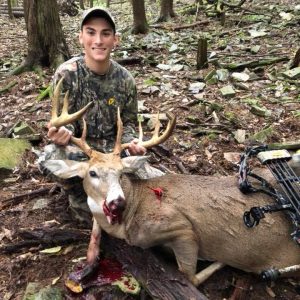 Hunter posing with trophy whitetail deer