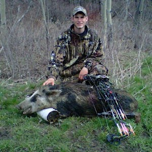 Man posing with hunted boar