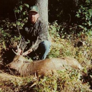 Man posing with sika deer