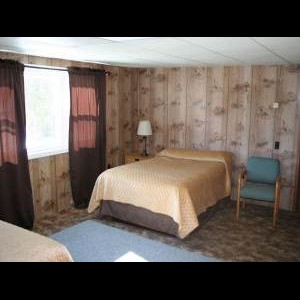 Queen bed inside Tioga Ranch Hunting Lodge
