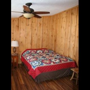 Queen bed inside Tioga Ranch Hunting Lodge